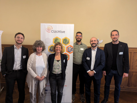 beehive team stood in front of beehive banner