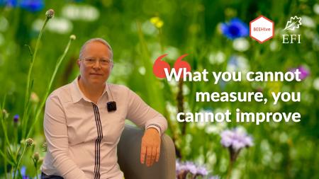 Erika Winquist sitting. Background close-up of flowers. Text says 'What you cannot measure, you cannot improve'