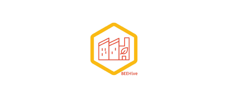 green cities logo of orange outline of cityscape over a green walled building 